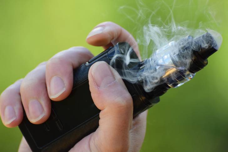 This is a photo of a hand holding a vape.